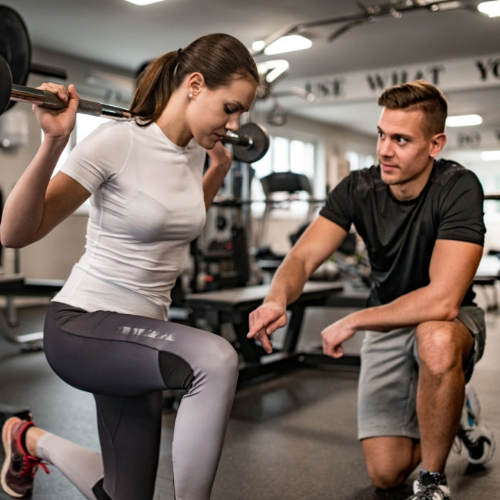 Personal trainer coaching a young woman